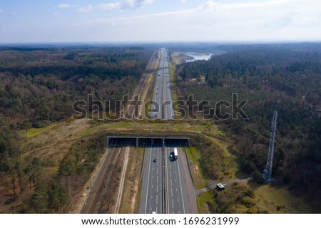 drone / aerial footage of a Wildlife / animal crossing over a dutch highway with lots of traffic. animal protection initiative. Royalty-Free Stock Photo #1696231999