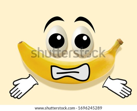 photo of a banana and eggs on a yellow background in the shape of a scared face with painted eyes and mouth