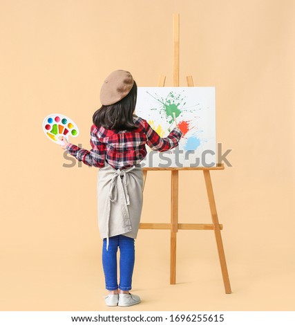 Cute little artist on color background Royalty-Free Stock Photo #1696255615