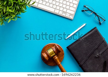 Judge gavel near documents and keyboard - lawyer concept - on blue background top-down copy space