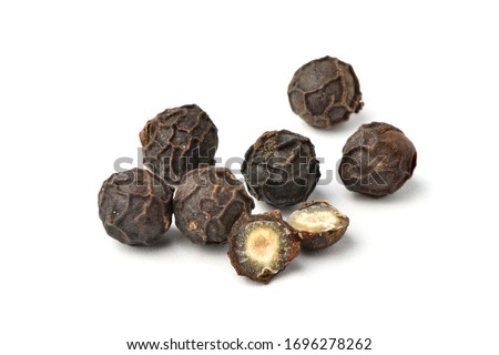 Close-up of Black peppercorns (Black pepper) seeds with cut in half isolated on white background. Royalty-Free Stock Photo #1696278262
