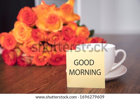 roses and coffee with good morning text on table
