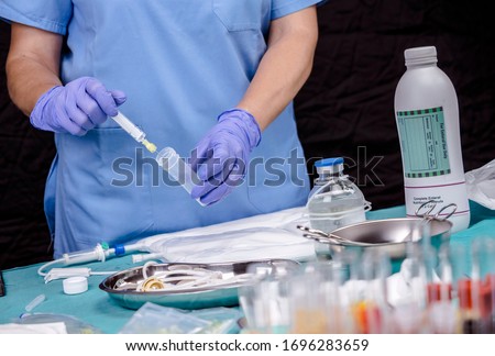 Nurse preparing medication for parenteral nutrition in a hospital, conceptual image Royalty-Free Stock Photo #1696283659