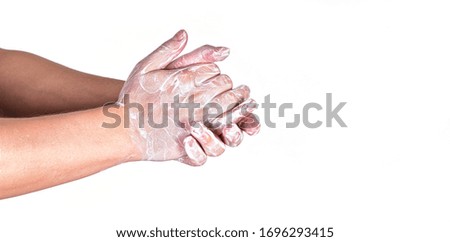 Young man wash hands with soap, closeup detail on soap bubbles, isolated on white, space for text right side. Can be used during coronavirus covid-19 outbreak prevention