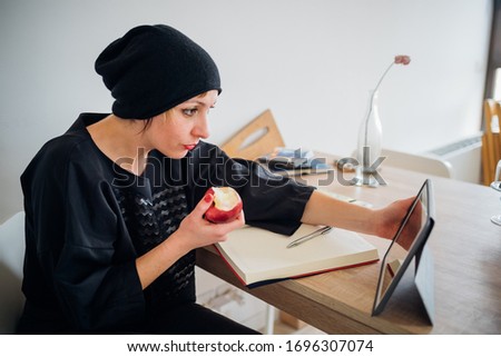 Adult caucasian woman indoors at home watching streaming using ipad - entertainment, watching, screen time concept