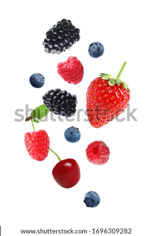 Set of falling sweet berries on white background