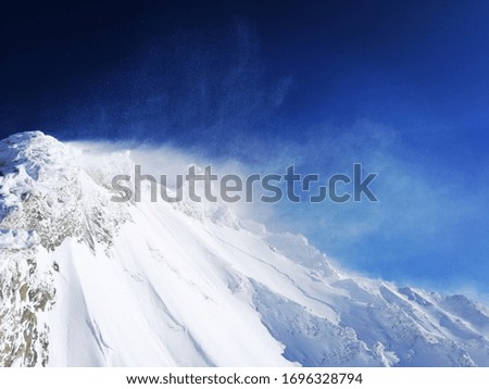 Top of snow covered mountains blue sky