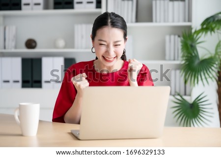 Excited female feeling euphoric celebrating online win success achievement result, young woman happy about good email news, motivated by great offer or new opportunity, passed exam, got a job Royalty-Free Stock Photo #1696329133