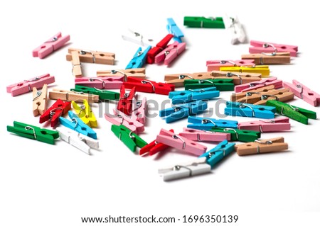 A lot of multi-colored clothespins on awhite background
