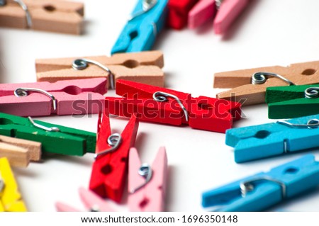 Many decorative colored pegs on a white background, macro closeup