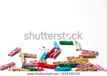 Colorful clothespins on a white background with place for text.