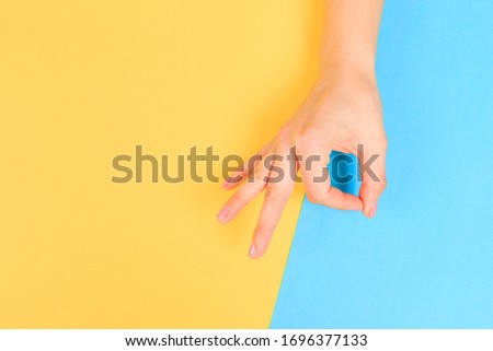 female  manicure. Beautiful young woman's hands in OK sign on pastel color  background