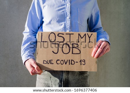 Man office worker in blue shirt with cardboard sign LOST JOB. Jobless, unemployment due covid-19 concept. Asking for money Royalty-Free Stock Photo #1696377406