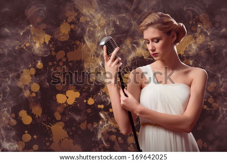 attractive female singer with a microphone behind her abstract background