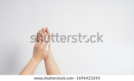 Hands washing gesture with foaming hand soap on white background.
