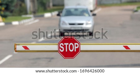 checkpoint of cars, slag arrow with a stop sign.
