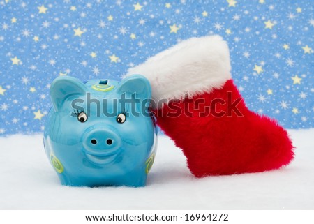 Piggy bank and red stocking sitting on snow with star background, Christmas savings