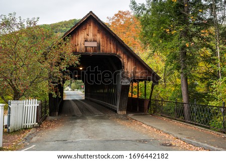 Empty traditional wooden covered bridge in autumn