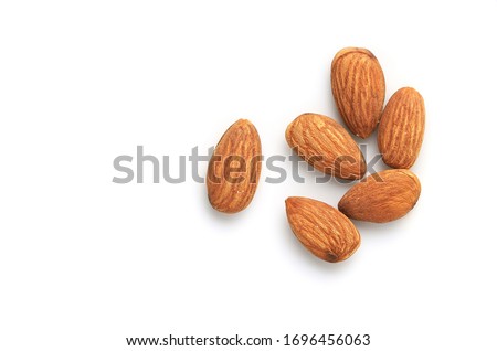 Many Almonds seeds isolate on a white background. Top view and clipping path Royalty-Free Stock Photo #1696456063