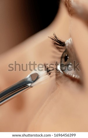 close up of cosmetic brush near eye of model