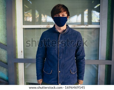 Young guy in a blue jacket and mask.