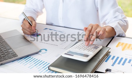 Accounting businessmen are calculating income-expenditure and analyzing real estate investment data, Financial and tax systems concept. Royalty-Free Stock Photo #1696478416