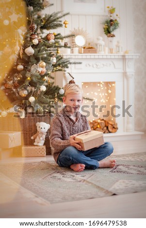 A boy in a new year's interior in gold color.