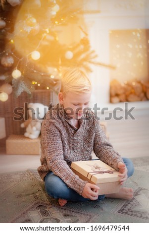 A boy in a new year's interior in gold color.