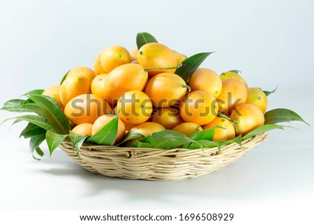 sweet yellow Marian plum thai fruit in basket background (Mayongchid Maprang Marian Plum and Plum Mango,Thailand) Royalty-Free Stock Photo #1696508929