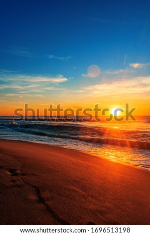 A vertical shot of the North Entrance Beach at sunrise under a blue sky