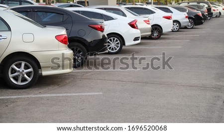 Closeup of rear, back side of golden car with  other cars parking in outdoor parking area  in sunny day. Royalty-Free Stock Photo #1696520068