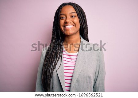 Young african american business woman standing over pink isolated background with a happy and cool smile on face. Lucky person.
