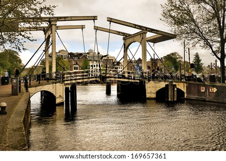 Beautiful Amsterdam canals with typical bridge