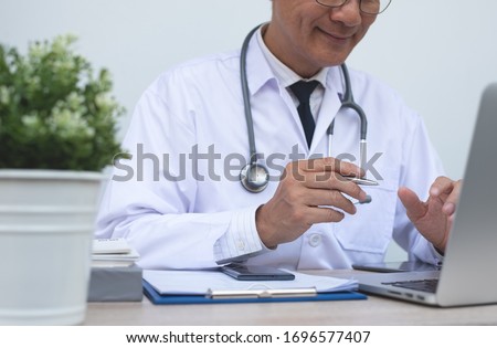 Telemedicine, Medical online, e health concept. Smiling doctor video chat with patient via laptop computer, mobile health application. Doctor video conferencing, cropped image.
