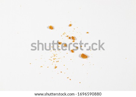 Scattered crumbs isolated on white background Royalty-Free Stock Photo #1696590880