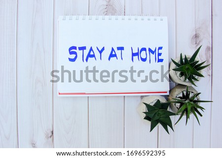 Write shows the “stay at home” sign on the wood background and have , Protect Spread during quarantine coronovirus covid -19.