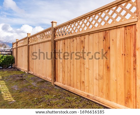 Fence built from wood. Outdoor landscape. Security and privacy concept. Vancouver. Canada. Royalty-Free Stock Photo #1696616185