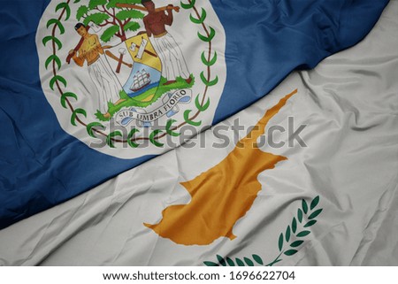 waving colorful flag of cyprus and national flag of belize. macro