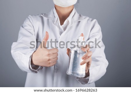  woman hand liquid gel and okay sign 