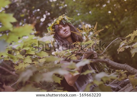 Young beautiful sad woman on tree