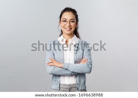 Career, business and education concept. Portrait of cheerful asian girl ready to start online lesson with students, explain class new theme, cross hands chest confident, smiling self-assured