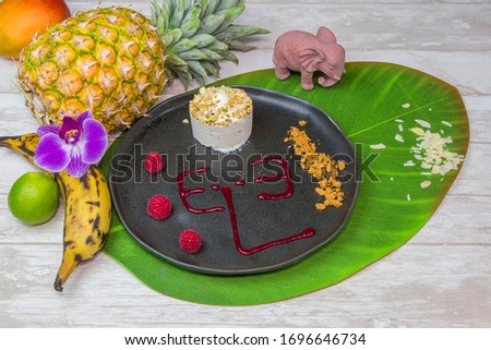 Thai food, Thai specialty dessert. Served with on a black plat, on a palm leaf, with fruits.