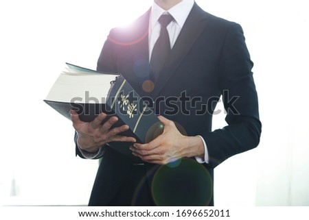 Lawyer holding law book.Chinese character 'beobjeon' means code of laws,law book.