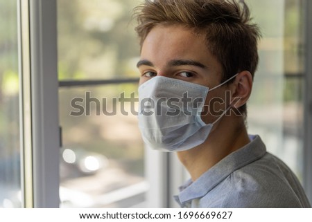 Quarantine, student at home isolation in a protective mask.