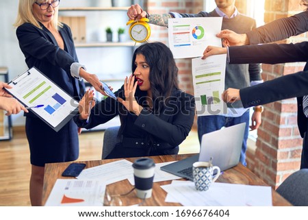 Group of business workers working together. Partners stressing one of them at the office