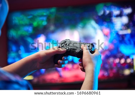 Gamer holding Gamepad, Controller or Videogame Joystick Console in hands. Close up, game concept Royalty-Free Stock Photo #1696680961