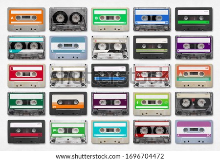 25 audio cassettes isolated on white background. Royalty-Free Stock Photo #1696704472