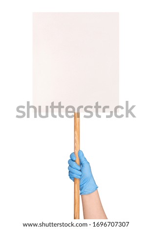 Protest sign in a hand in a blue medical glove, isolated on white background