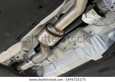 Catalytic converter of a modern car bottom view.	 Royalty-Free Stock Photo #1696725175