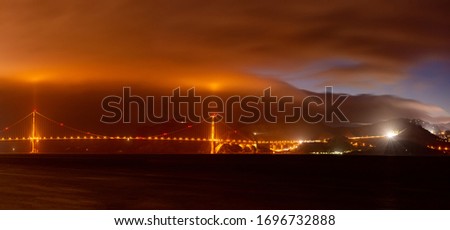 Golden bridge San Francisco mountains in the background in the fog, the night